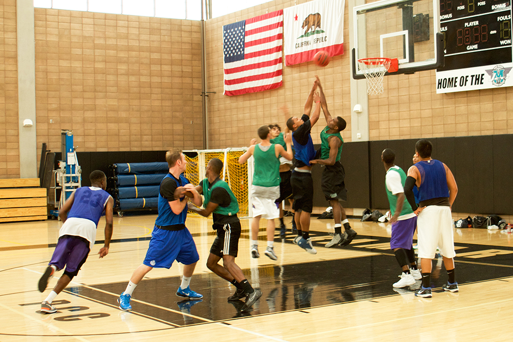 Photo of men playing basketball inside the Hourglass Fieldhouse gym
